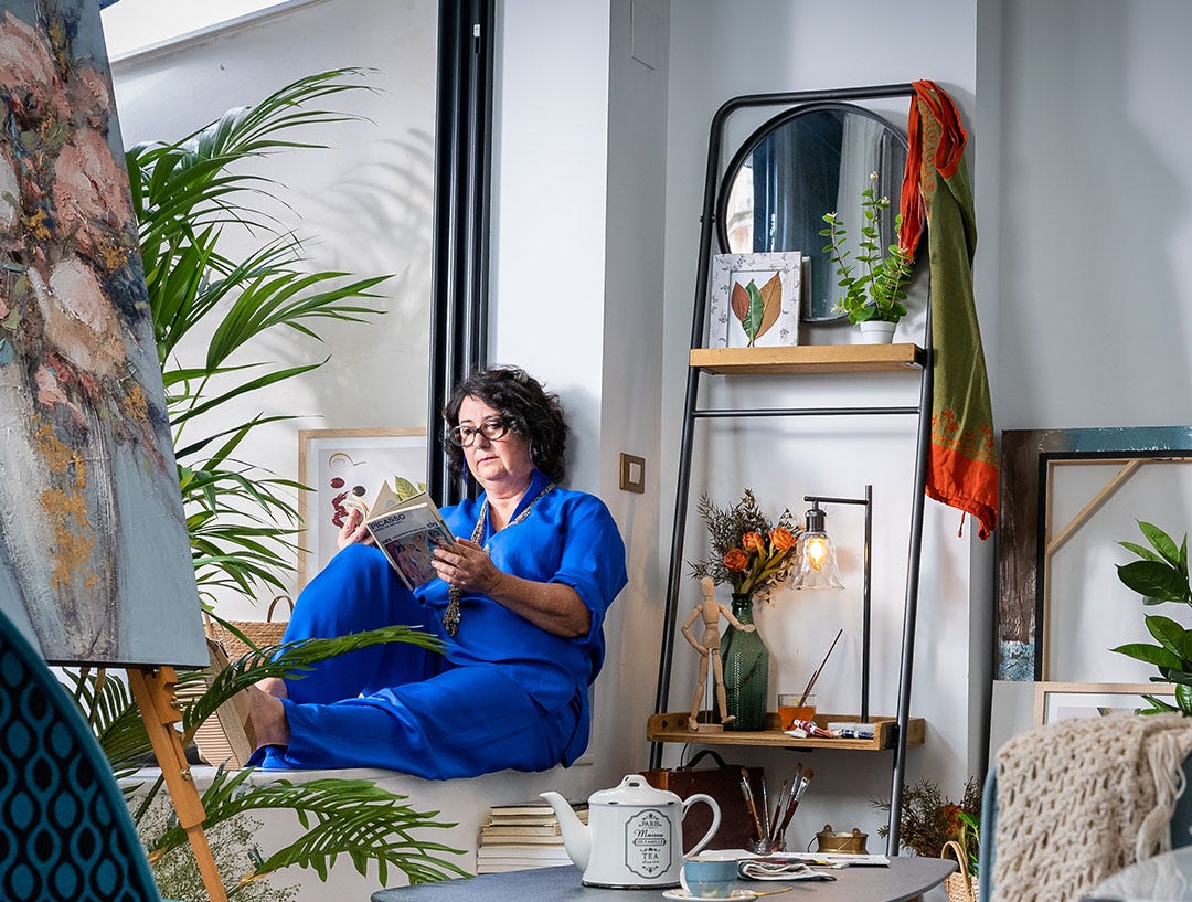 Mujer leyendo al lado de una ventana